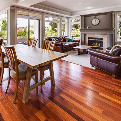 Living room and dining area with table with floors installed by hardwood flooring company near Santa Monica, CA.