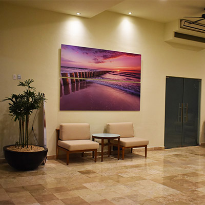 View of reception area with a plant, art work on wall, two chairs and laminate floors near Simi Valley, CA by ASAP Flooring Services.