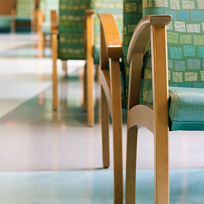 Seating area with close up view of rows of seating and laminate floor from flooring company near Simi Valley, CA.